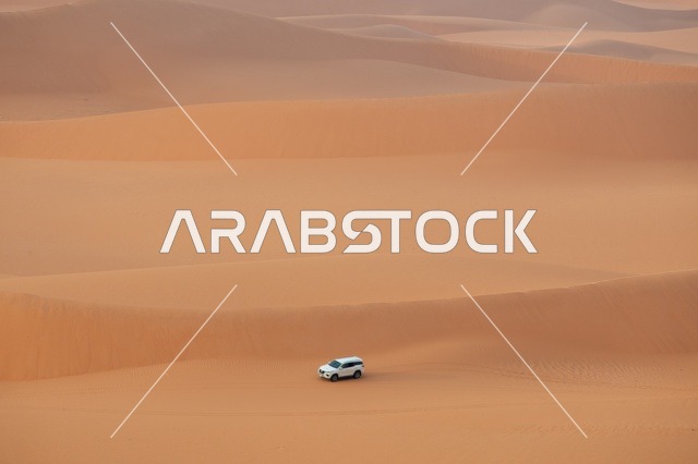 White SUV Driving Through Al-Nafud Desert Dunes