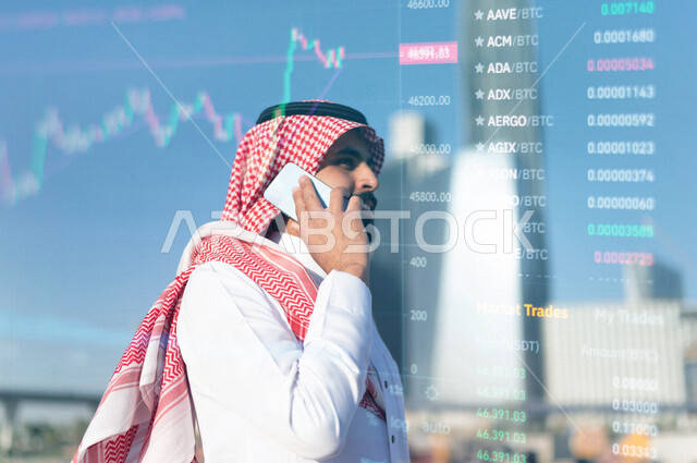 Close-up of a Saudi Arabian Gulf Arab man making a phone call, stock exchange statistical 3D hologram graphic background, financial investment, economic monitoring and financial information