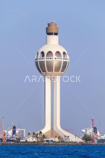 Lighthouse and traffic control tower as a symbol of the port of Jeddah, Saudi Arabia. Vertical photo