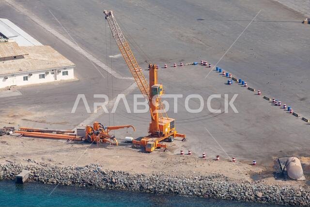Yellow port crane is a port on a sunny day. Red sea coast, Saudi Arabia