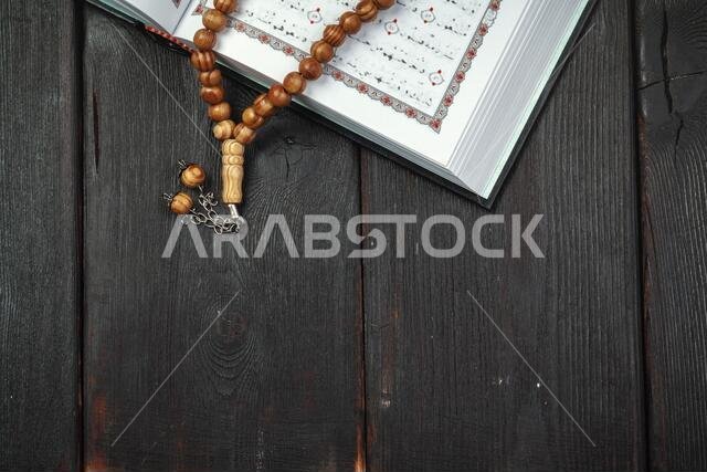 The Open holy Quran with tasbih/rosary beads close up