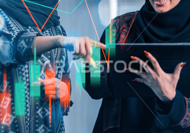 Two Saudi Arabian Gulf women inside a Saudi company, using tablet technicians, sales data analysis and economic growth chart, business and financial strategy, digital analytics and feasibility studies, 3D hologram charts