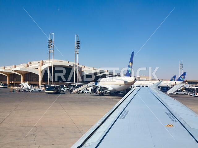 Riyadh - March 01:  Planes preparing for take off at Riyadh King Khalid Airport on March 01, 2016 in Riyadh, Saudi Arabia. Riyadh airport is home port