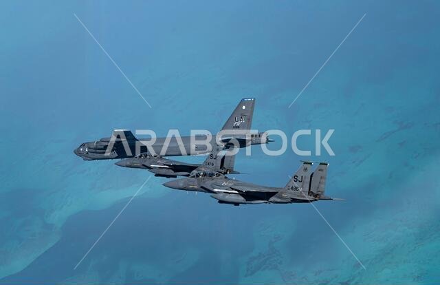Persian Gulf, Saudi Arabia. 27th Jan, 2021. A U.S. Air Force B-52 Stratofortress strategic bomber from the 2nd Bomb Wing flies escorted by U.S. and Royal Saudi Air Force F15 Strike Eagle fighter aircraft during a short-duration deployment to the middle east January 27, 202 over the Persian Gulf. Credit: Planetpix/Alamy Live News