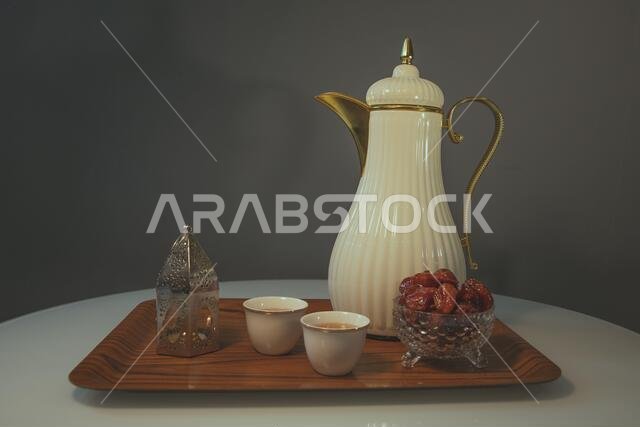 Dates, Arabic coffee and Islamic lantern inside a wooden bowl. Ramadan symbol