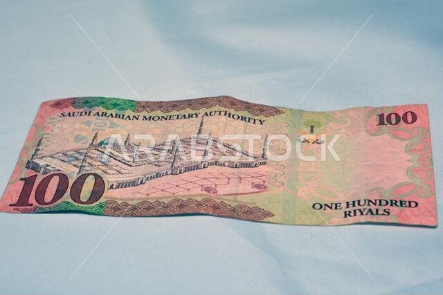 Saudi Arabia 100 riyal banknote, The Saudi riyal is the currency of Saudi Arabia, selective focus of Saudi kingdom cash money.