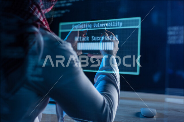 A Saudi Arabian Gulf man using his mobile phone, exposure to hacking and electronic attacks, security penetration, penetration of the protection, security and privacy of users, electronic crimes, cell phone protection from penetration