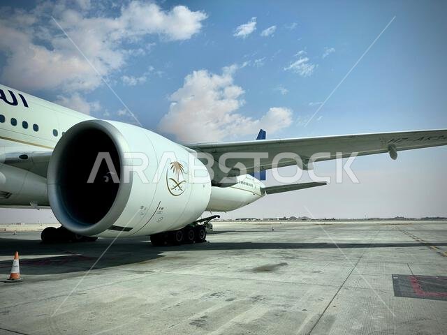Riyadh , Saudi Arabia - Mar 11 2023 : Passengers traveling through Saudi Airlines flight - Airplane from outside flight  and booking concept