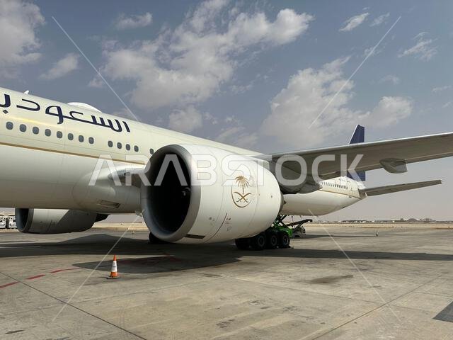 Riyadh , Saudi Arabia - Mar 11 2023 : Passengers traveling through Saudi Airlines flight - Airplane from outside flight  and booking concept