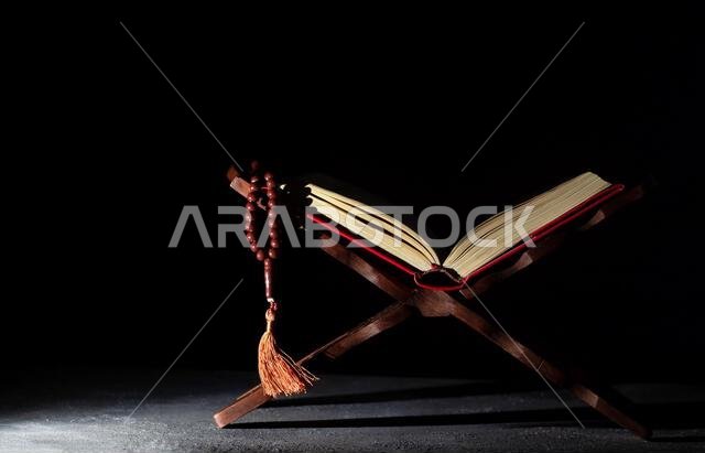 Quran and rosary, the holy book of muslims on rahle, ramadan and holy night concept