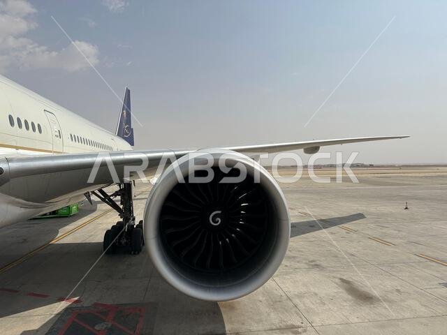 Riyadh , Saudi Arabia - Mar 11 2023 : Passengers traveling through Saudi Airlines flight - Airplane from outside flight  and booking concept