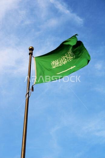 Saudi Arabia national flag waving in the sky. Islamic religion flag.