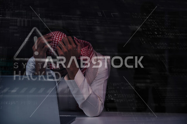 A Saudi Arabian Gulf man sitting in front of a laptop with gestures indicating sadness, exposure to hacking and electronic attacks, theft of passwords and personal data, penetration of the system and data, electronic crimes, programming codes, background 