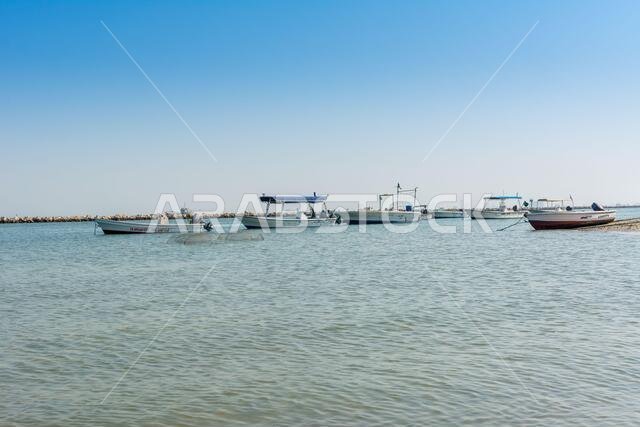 Fishing boat sailing at the sea in the corniche park, the city of Dammam, Kingdom of Saudi Arabia.
