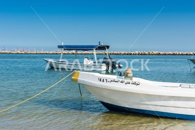 Fishing boat at the beach with background of sea in the corniche park, the city of Dammam, Kingdom of Saudi Arabia.