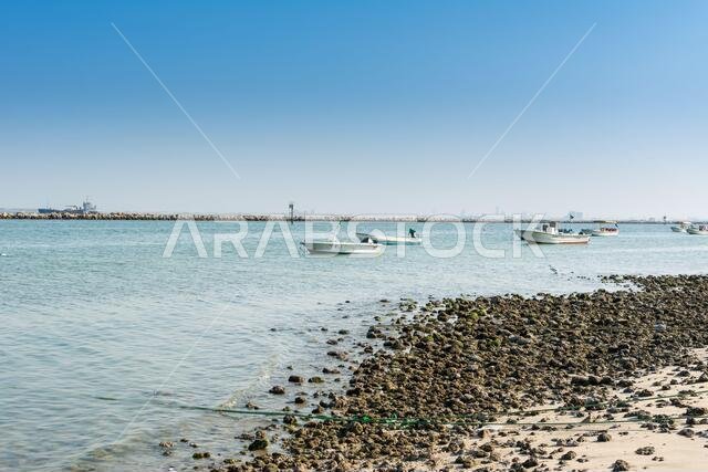 Fishing boat sailing at the sea in the corniche park, the city of Dammam, Kingdom of Saudi Arabia.
