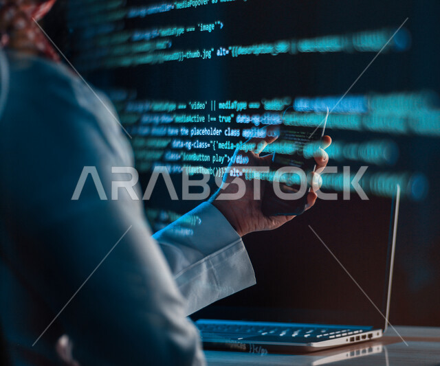 A Saudi Arabian Gulf man working as a web developer, using programming languages, developing and building websites and electronic applications, codes and algorithms, computer and techniques, hacker, hacking, information protection, information security