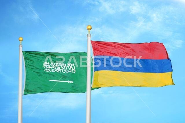 Saudi Arabia and Armenia two flags on flagpoles and blue cloudy sky