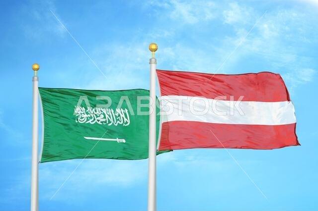 Saudi Arabia and Austria two flags on flagpoles and blue cloudy sky