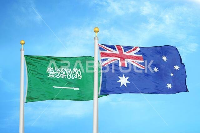 Saudi Arabia and Australia two flags on flagpoles and blue cloudy sky