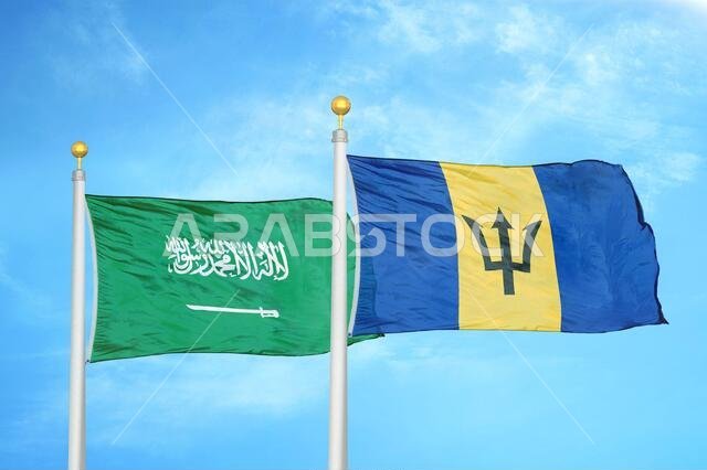 Saudi Arabia and Barbados two flags on flagpoles and blue cloudy sky