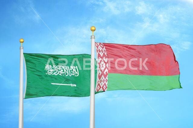 Saudi Arabia and Belarus two flags on flagpoles and blue cloudy sky