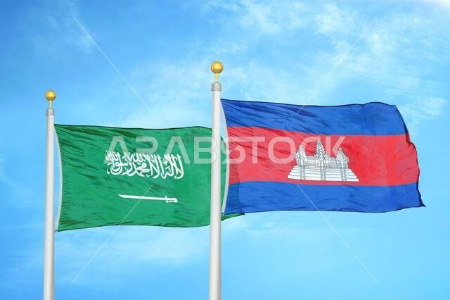 Saudi Arabia and Cambodia two flags on flagpoles and blue cloudy sky