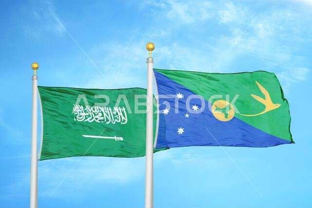 Saudi Arabia and Christmas Island two flags on flagpoles and blue cloudy sky