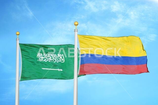 Saudi Arabia and Colombia two flags on flagpoles and blue cloudy sky
