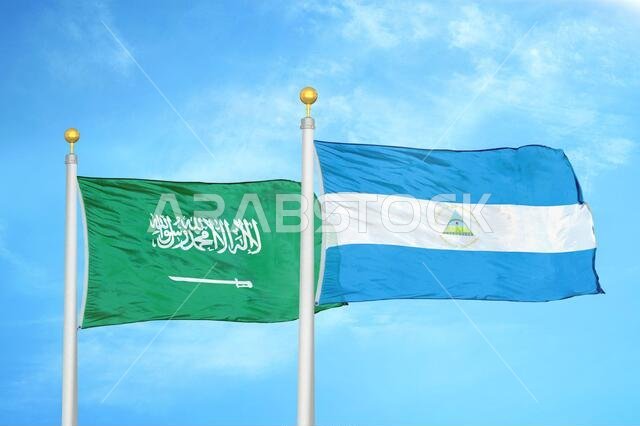 Saudi Arabia and Nicaragua two flags on flagpoles and blue cloudy sky
