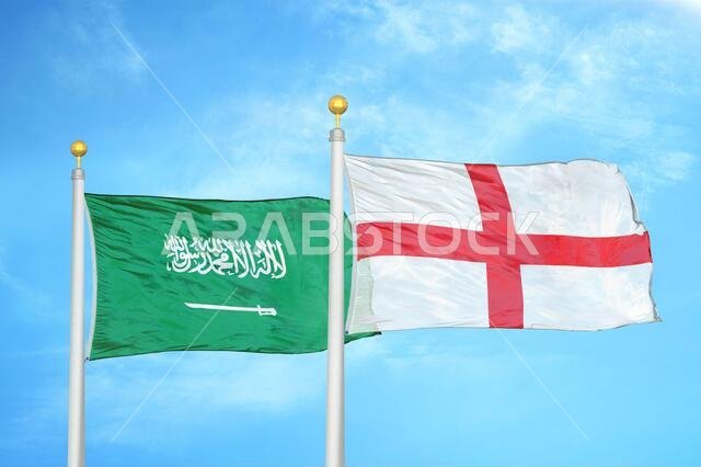 Saudi Arabia and England two flags on flagpoles and blue cloudy sky