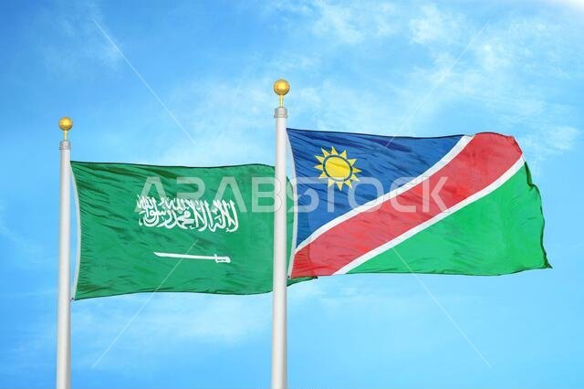 Saudi Arabia and Namibia two flags on flagpoles and blue cloudy sky
