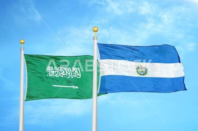 Saudi Arabia and El Salvador two flags on flagpoles and blue cloudy sky