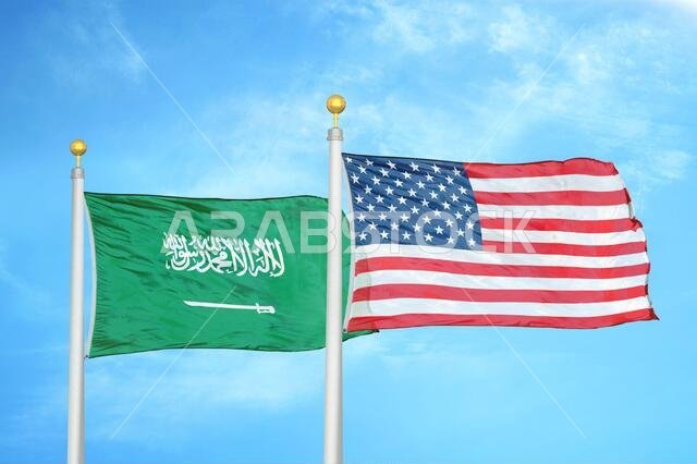 Saudi Arabia and United States two flags on flagpoles and blue cloudy sky