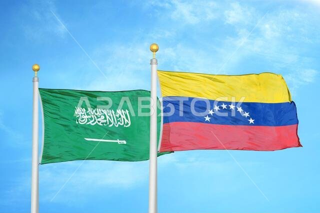Saudi Arabia and Venezuela two flags on flagpoles and blue cloudy sky