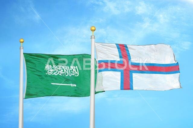 Saudi Arabia and Faroe Islands two flags on flagpoles and blue cloudy sky