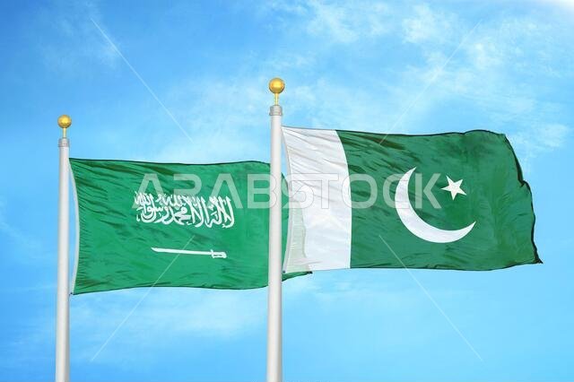 Saudi Arabia and Pakistan two flags on flagpoles and blue cloudy sky