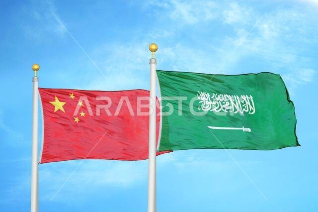 China and Saudi Arabia two flags on flagpoles and blue cloudy sky