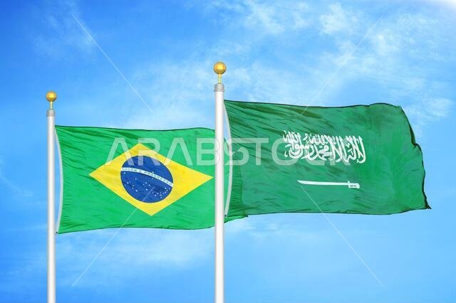 Brazil and Saudi Arabia two flags on flagpoles and blue cloudy sky