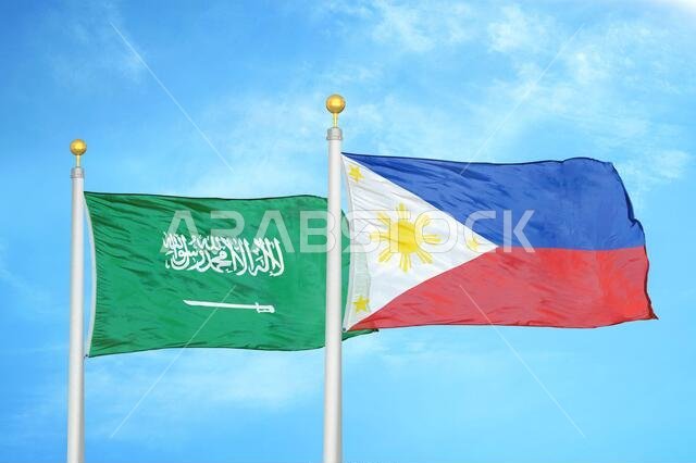 Saudi Arabia and Philippines two flags on flagpoles and blue cloudy sky