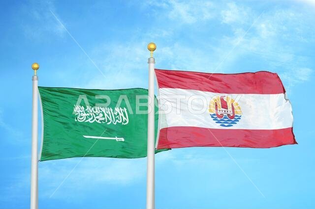Saudi Arabia and French Polynesia two flags on flagpoles and blue cloudy sky