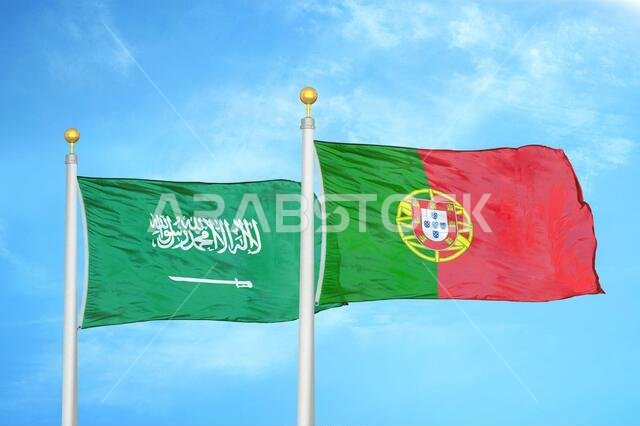 Saudi Arabia and Portugal two flags on flagpoles and blue cloudy sky