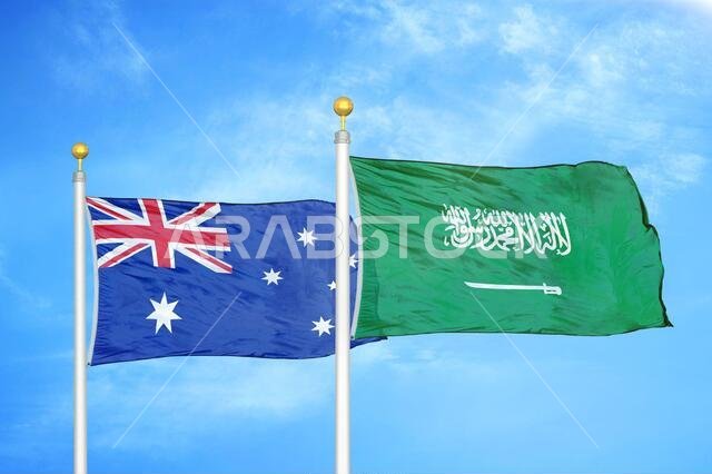Australia and Saudi Arabia two flags on flagpoles and blue cloudy sky