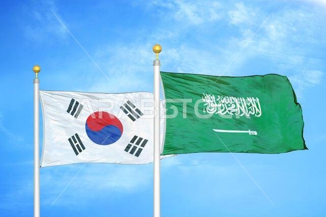 South Korea and Saudi Arabia two flags on flagpoles and blue cloudy sky