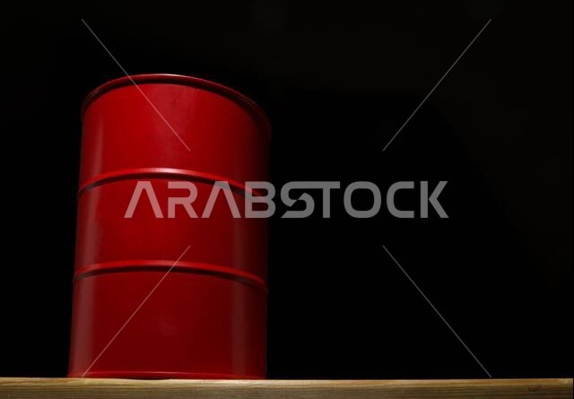 Red barrel of oil on a black background for design.