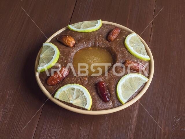 Saudi Arabia traditional dish Hineni, it is a mixed of dates and whole wheat. Ramadan food. Saudi Arabia traditional dish Hineni, it is a mixed of dates and whole wheat. Ramadan food.