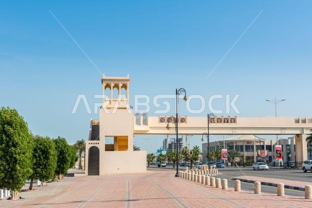 A footbridge with background of modern shopping mall  near the corniche park in Dammam city, Kingdom of Saudi Arabia