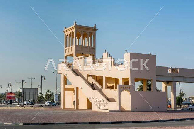 A footbridge with background of modern shopping mall  near the corniche park in Dammam city, Kingdom of Saudi Arabia