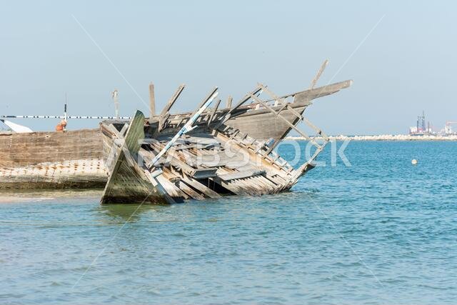 Broken old wooden fish boats abandoned at the bay in the corniche park, Dammam, Kingdom of Saudi Arabia