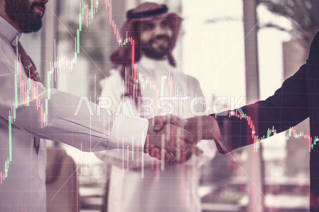 Two businessmen shake hands to complete a profitable deal, a business agreement, a project and a new business plan, business partners, progress and success, a Saudi company with high efficiency, hologram graphics.